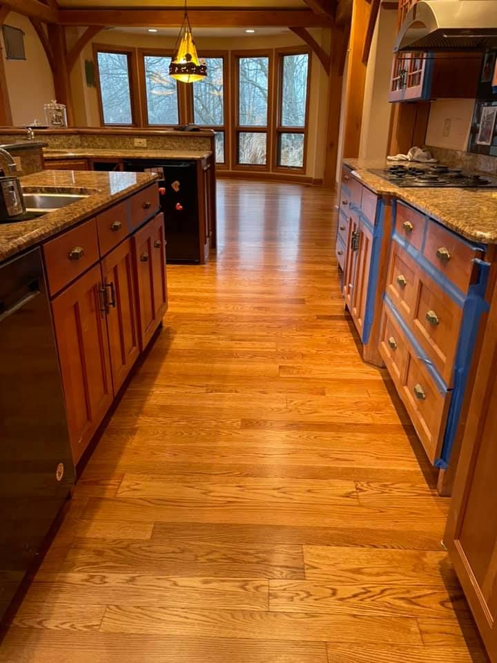 A kitchen with hardwood floors and granite counter tops.