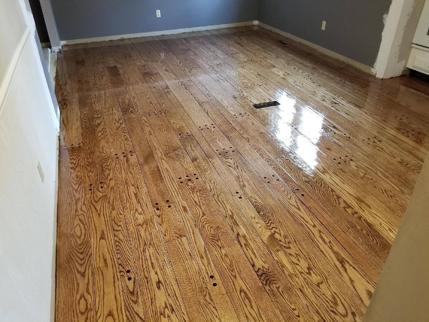 A living room with hardwood floors and gray walls.