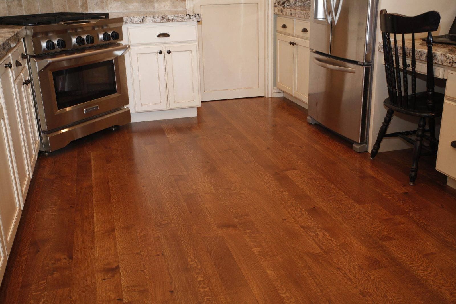 A kitchen with hardwood floors and stainless steel appliances