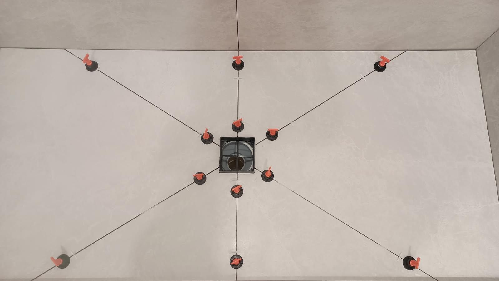 Overhead view of a ceiling with a central square air vent, with strings radiating outwards, connected by red markers.