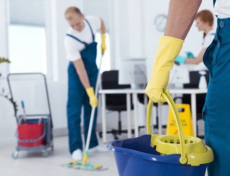 person holding mop pail and man cleaning floor