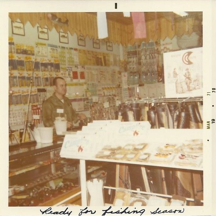 A photo of a man in a store that says ready for fishing seasons