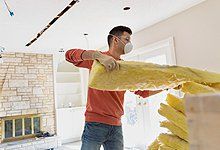 Young Man Installing Insulation at Home