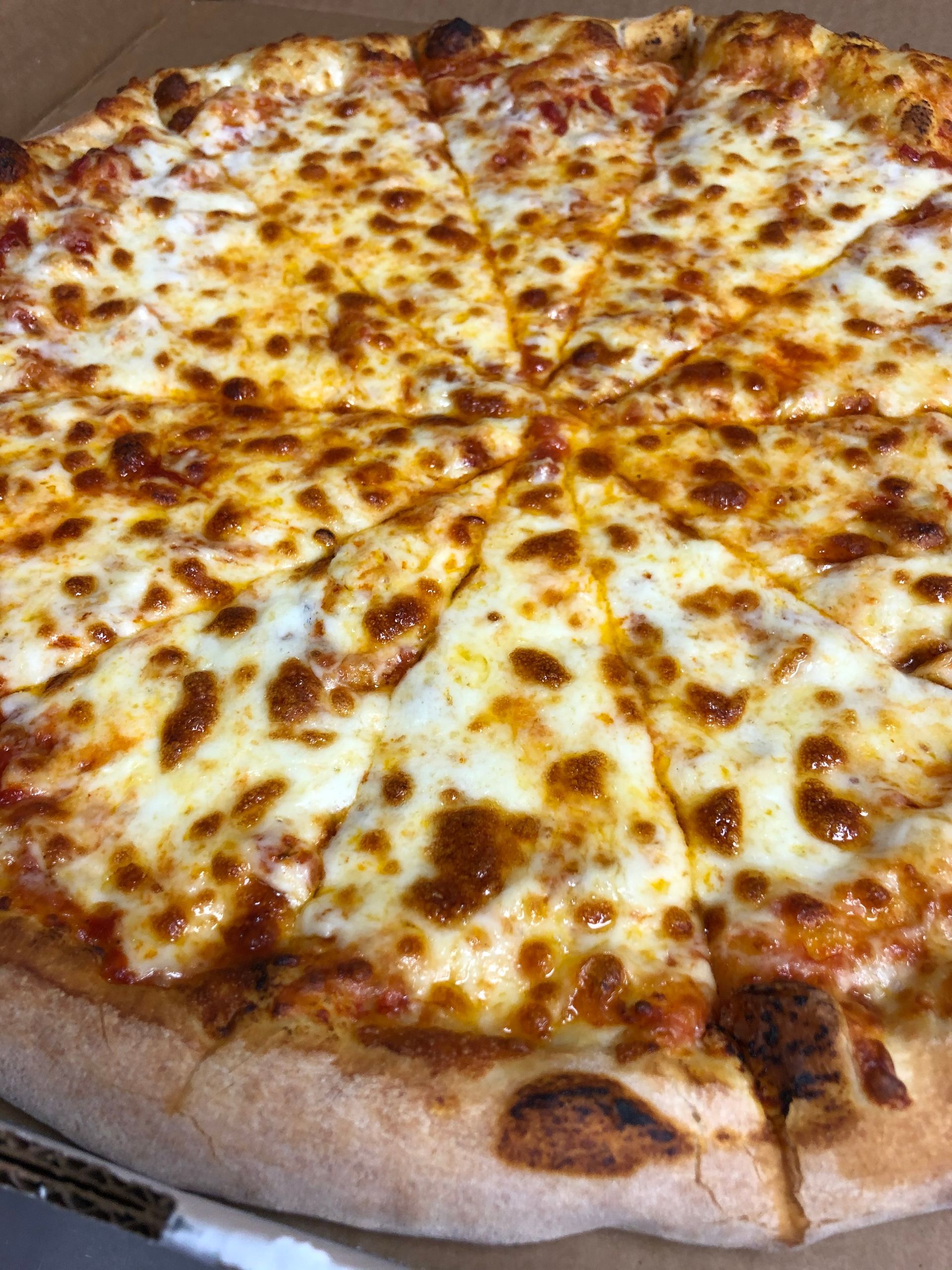 a pizza with a slice taken out of it is in a box