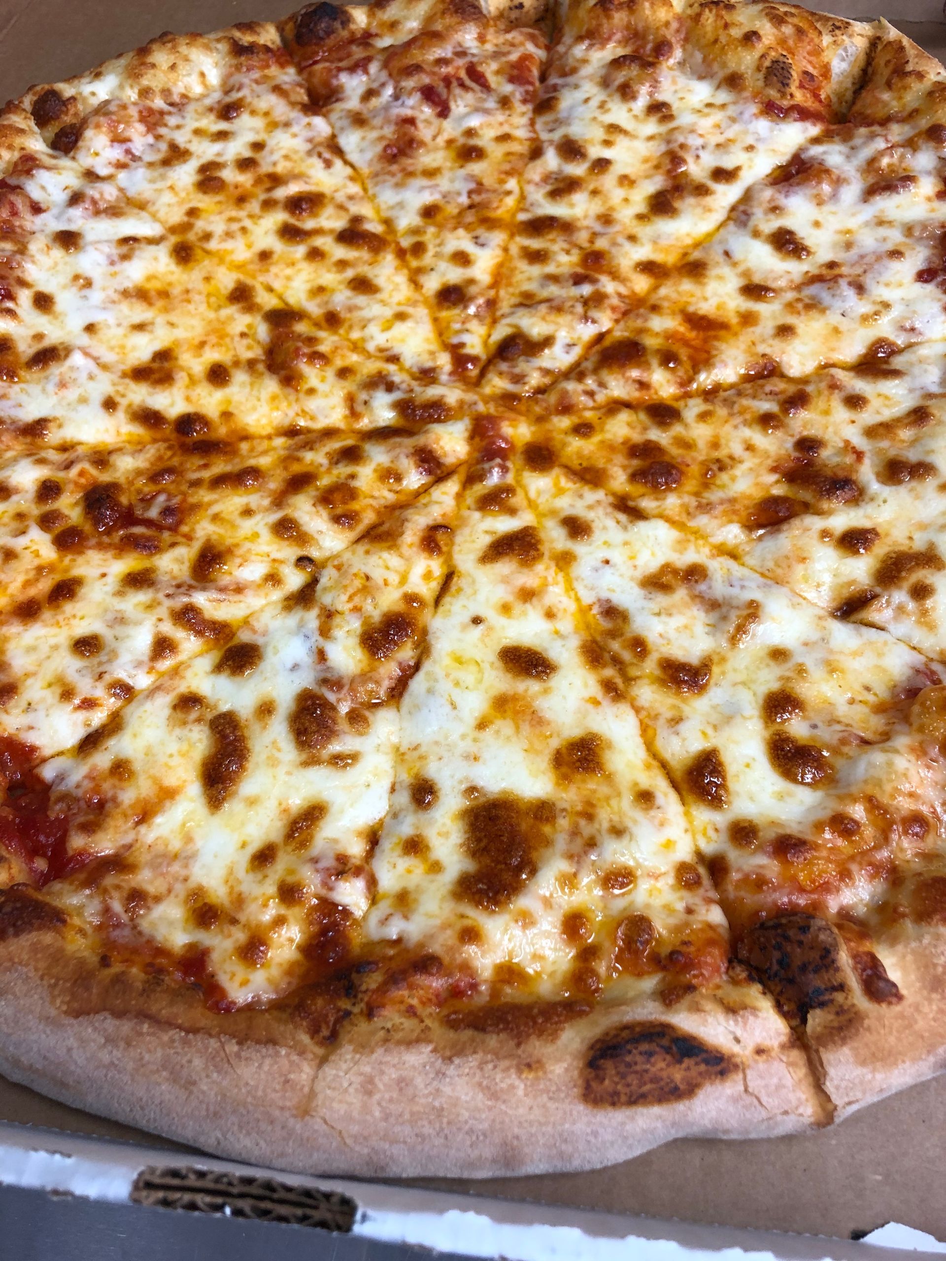 a large cheese pizza is sitting in a cardboard box