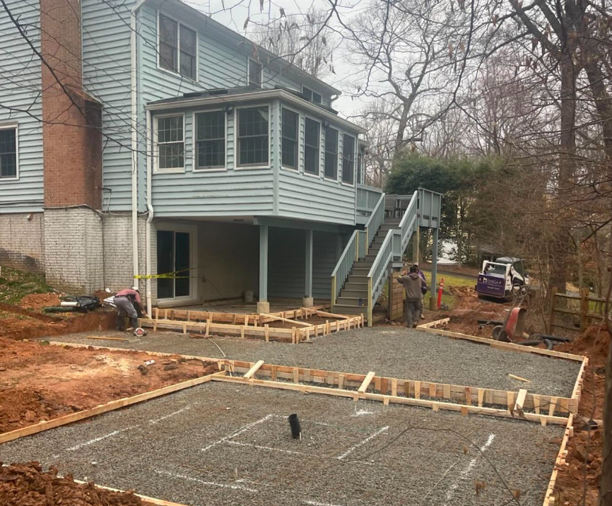 A house is being built with a large deck and stairs.