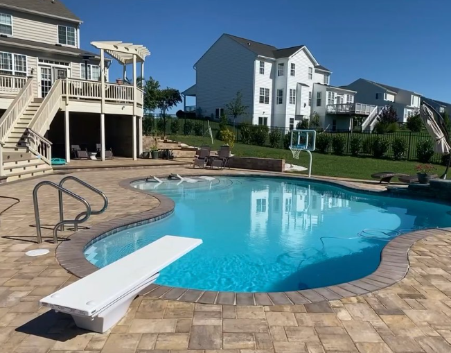 A large swimming pool with a diving board in the middle