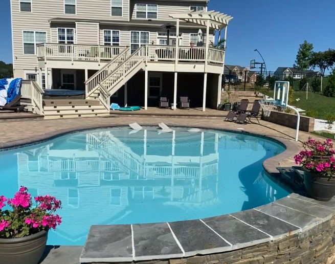 A large house with a large swimming pool in front of it