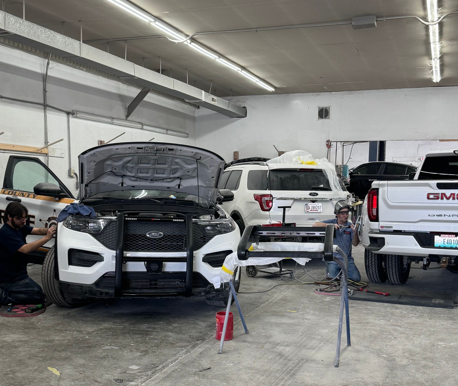A man is working on a car in a garage.