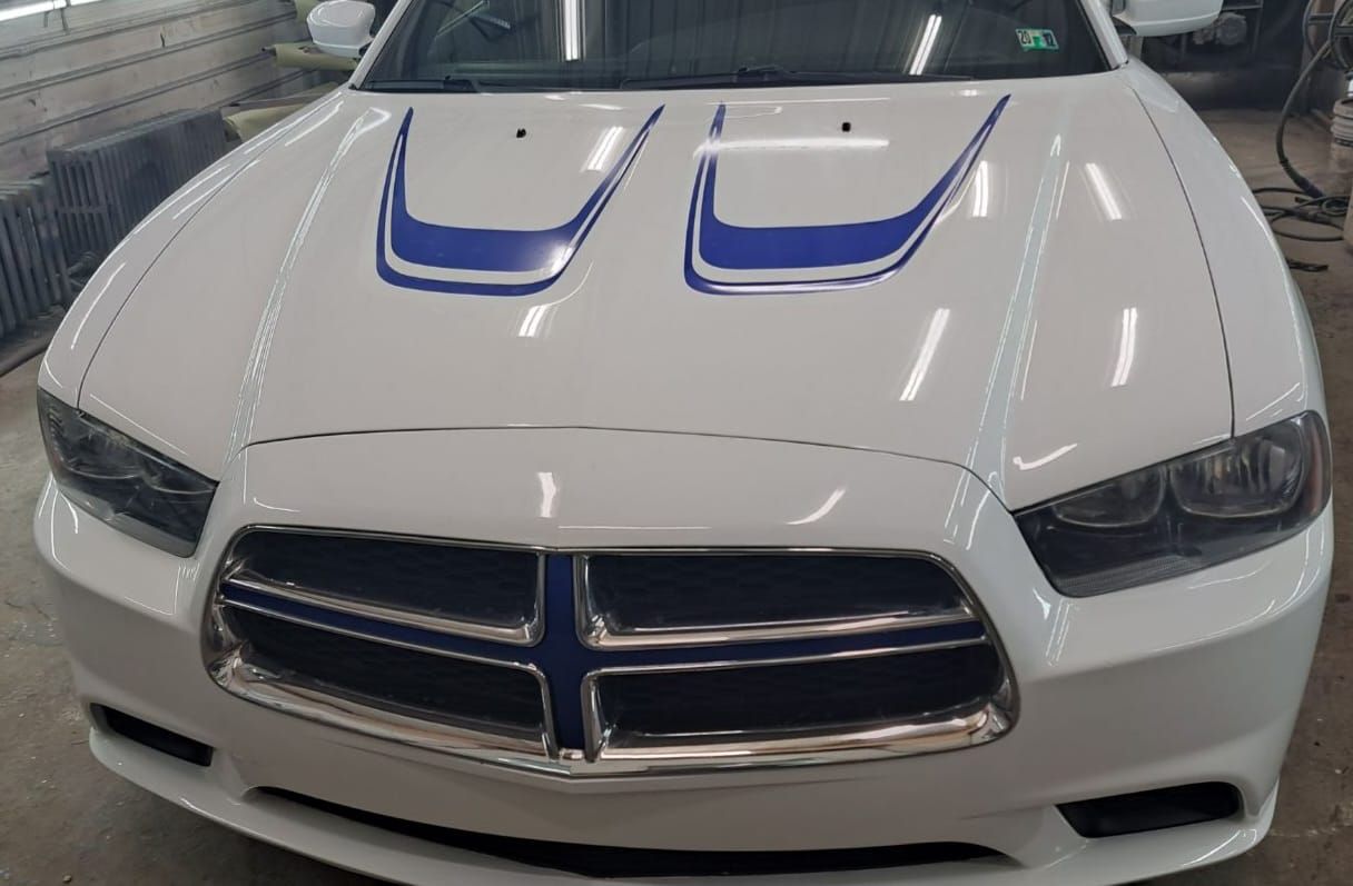 White Dodge Charger with blue hood stripes.
