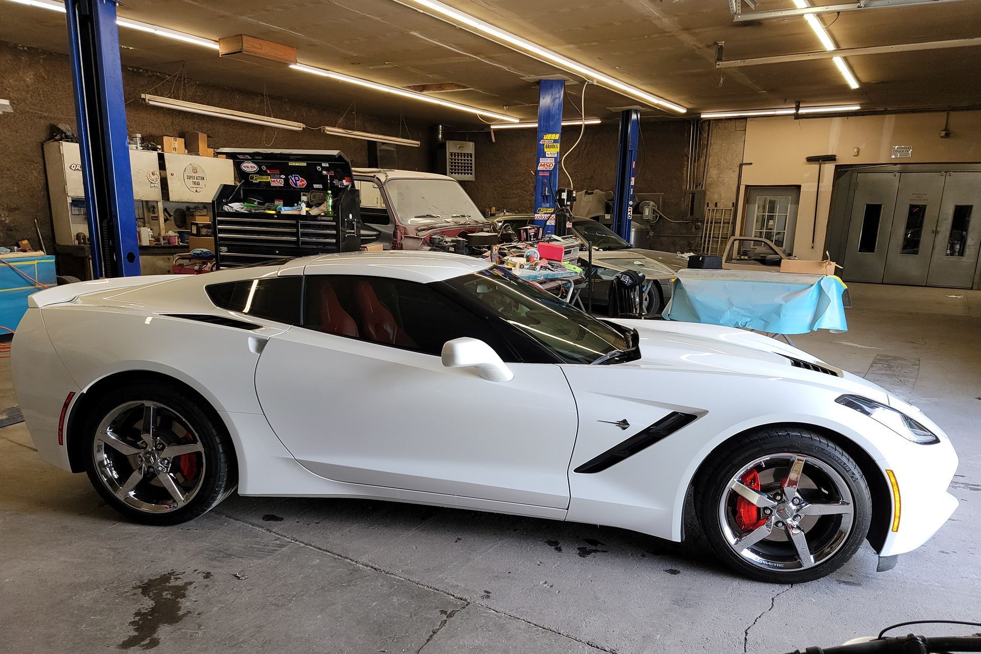 a white sports car is parked in a garage