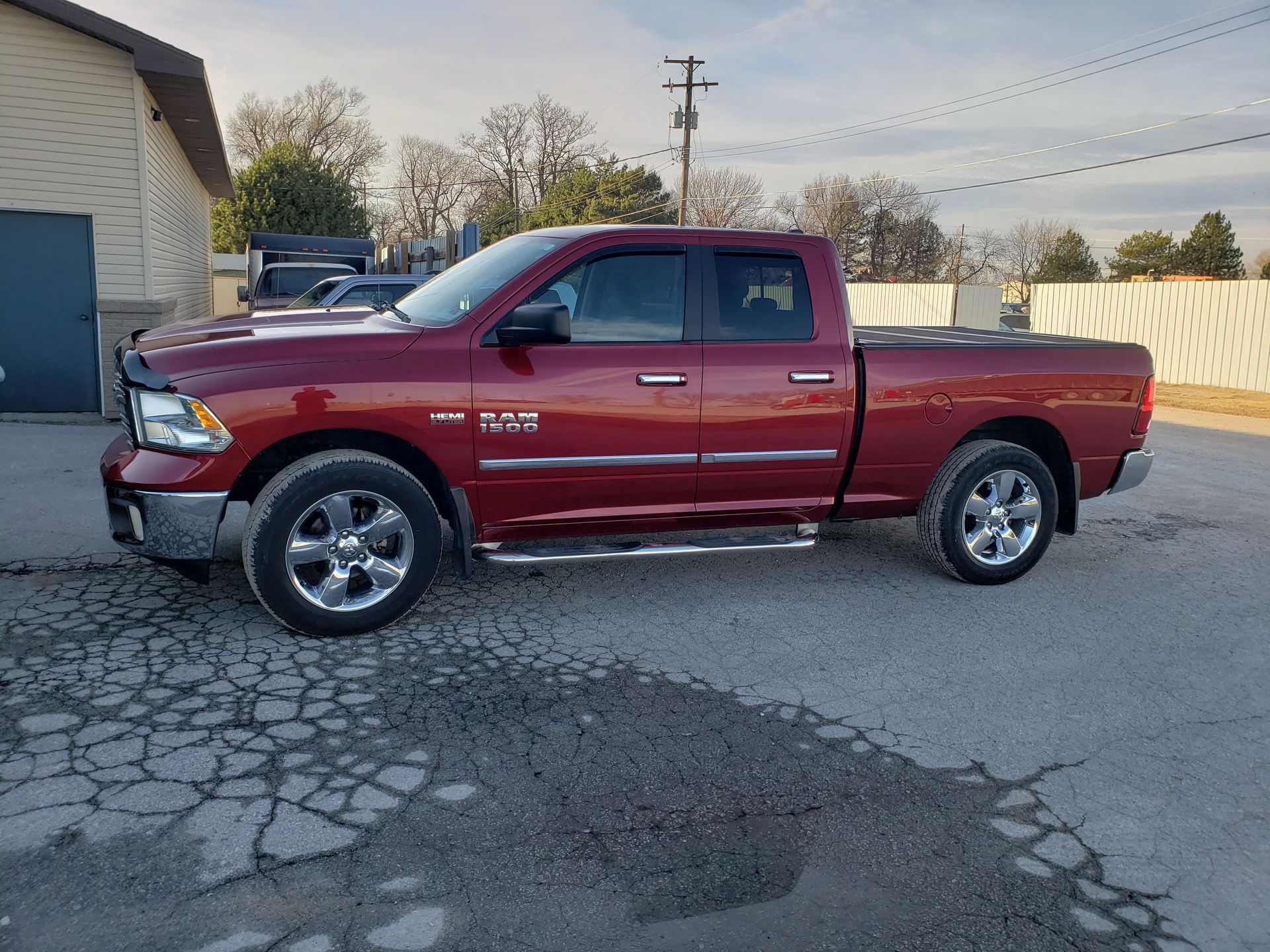 a red ram truck is parked in front of a building