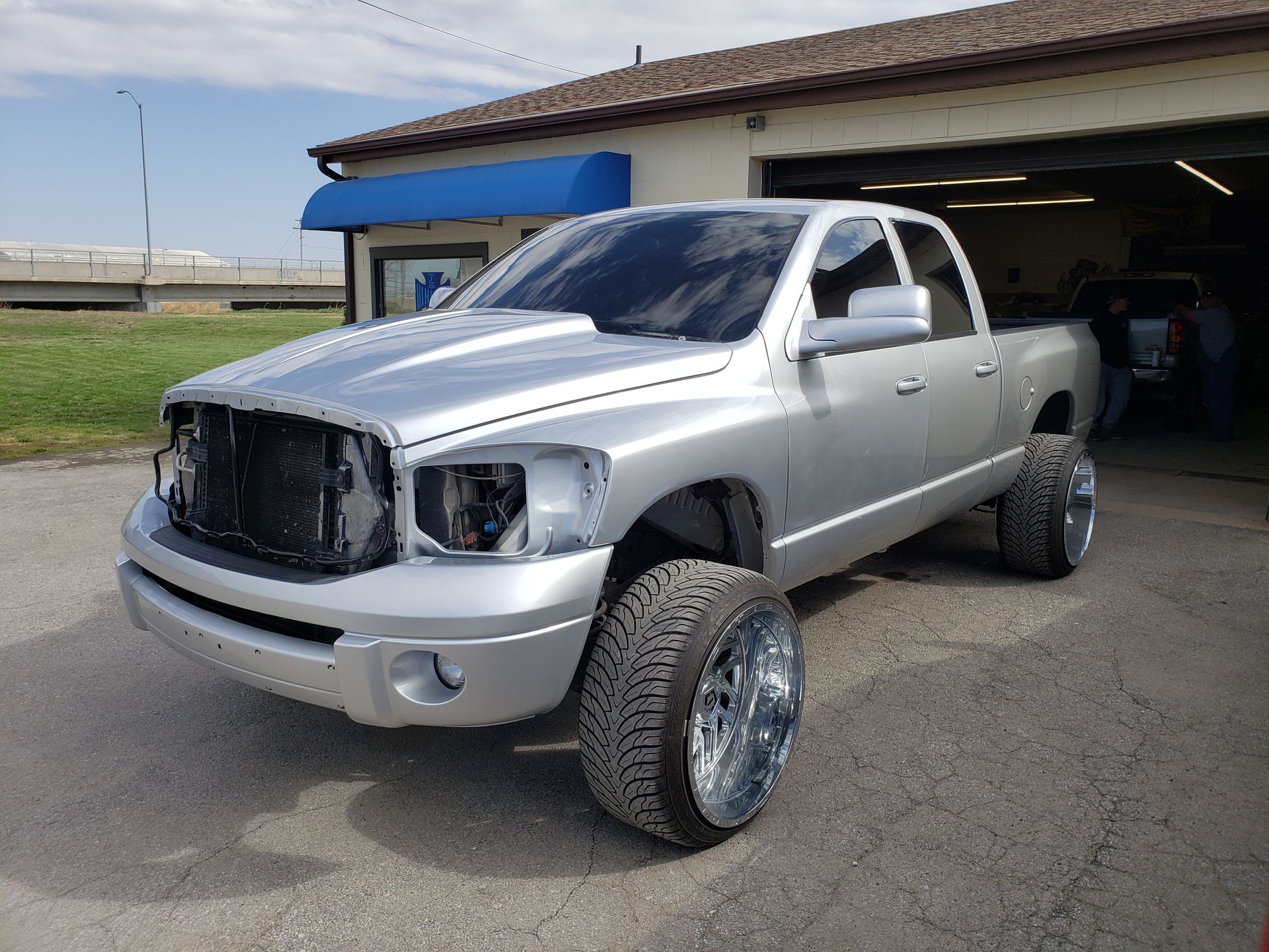 a silver truck is parked in front of a garage