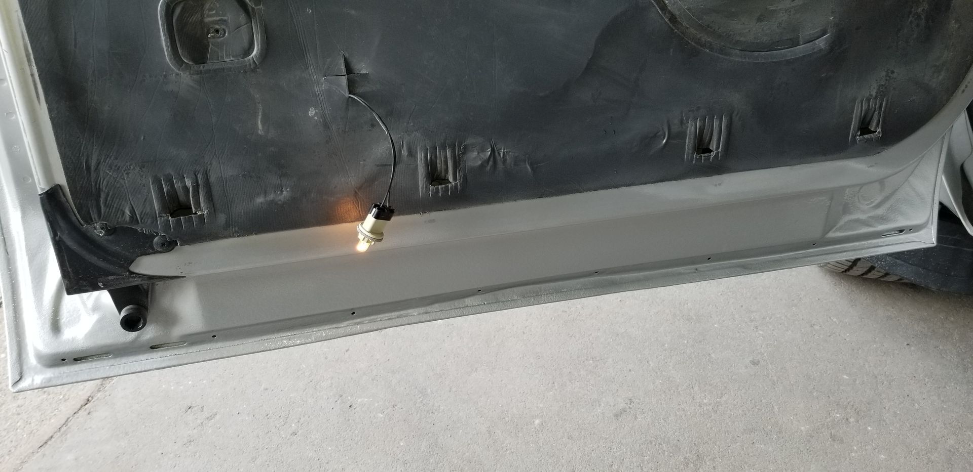 a close up of a car door with a light on it