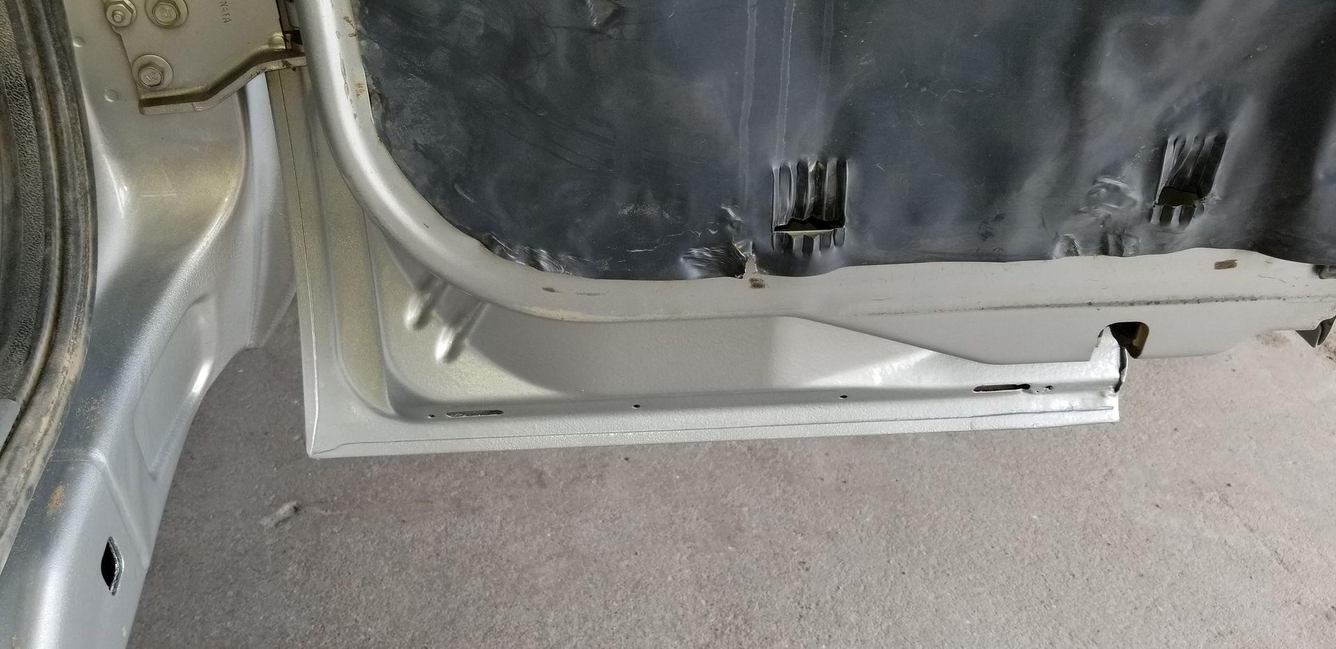 a close up of a car door with a hole in it