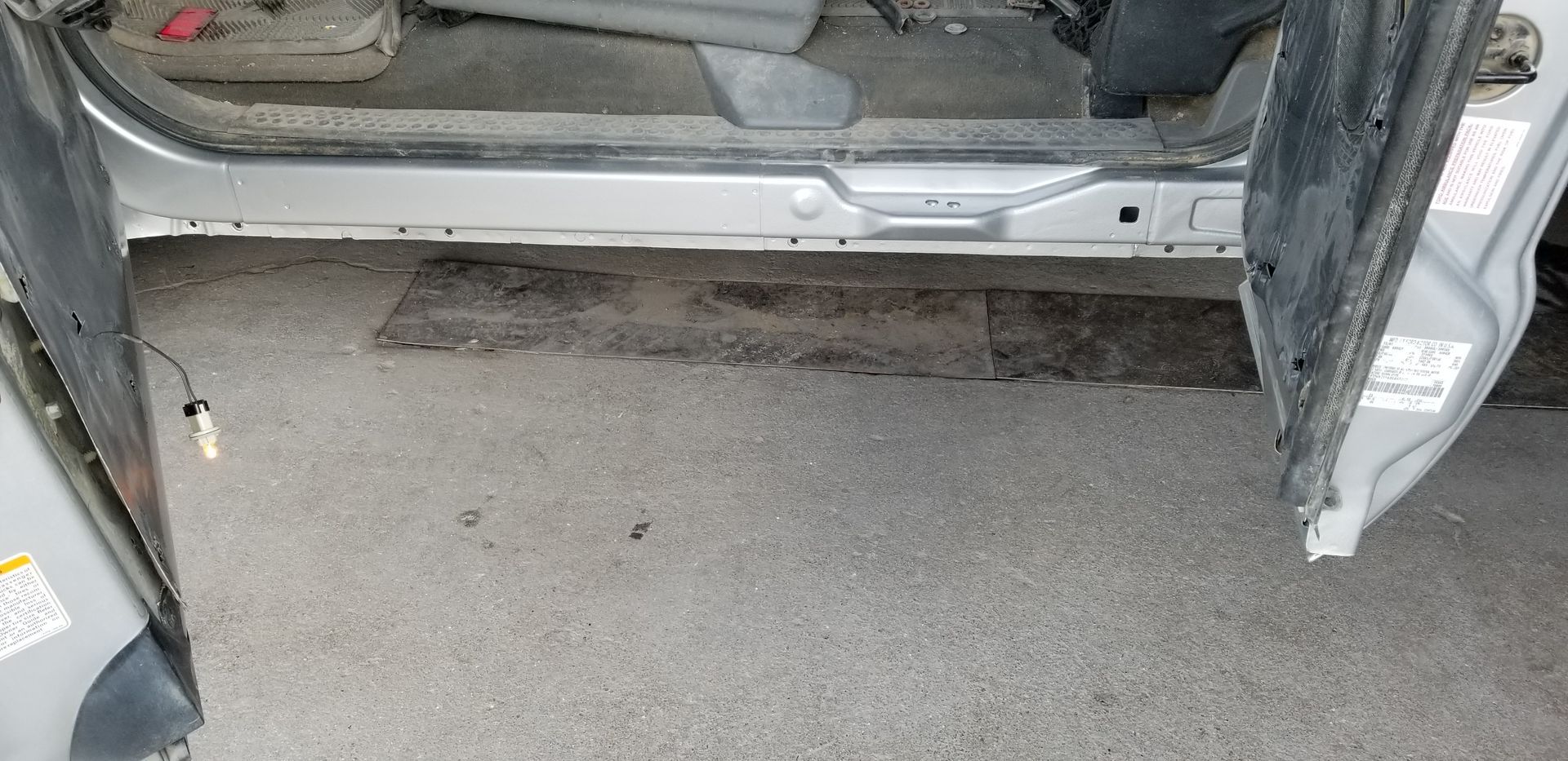 a car is parked in a garage with the door open