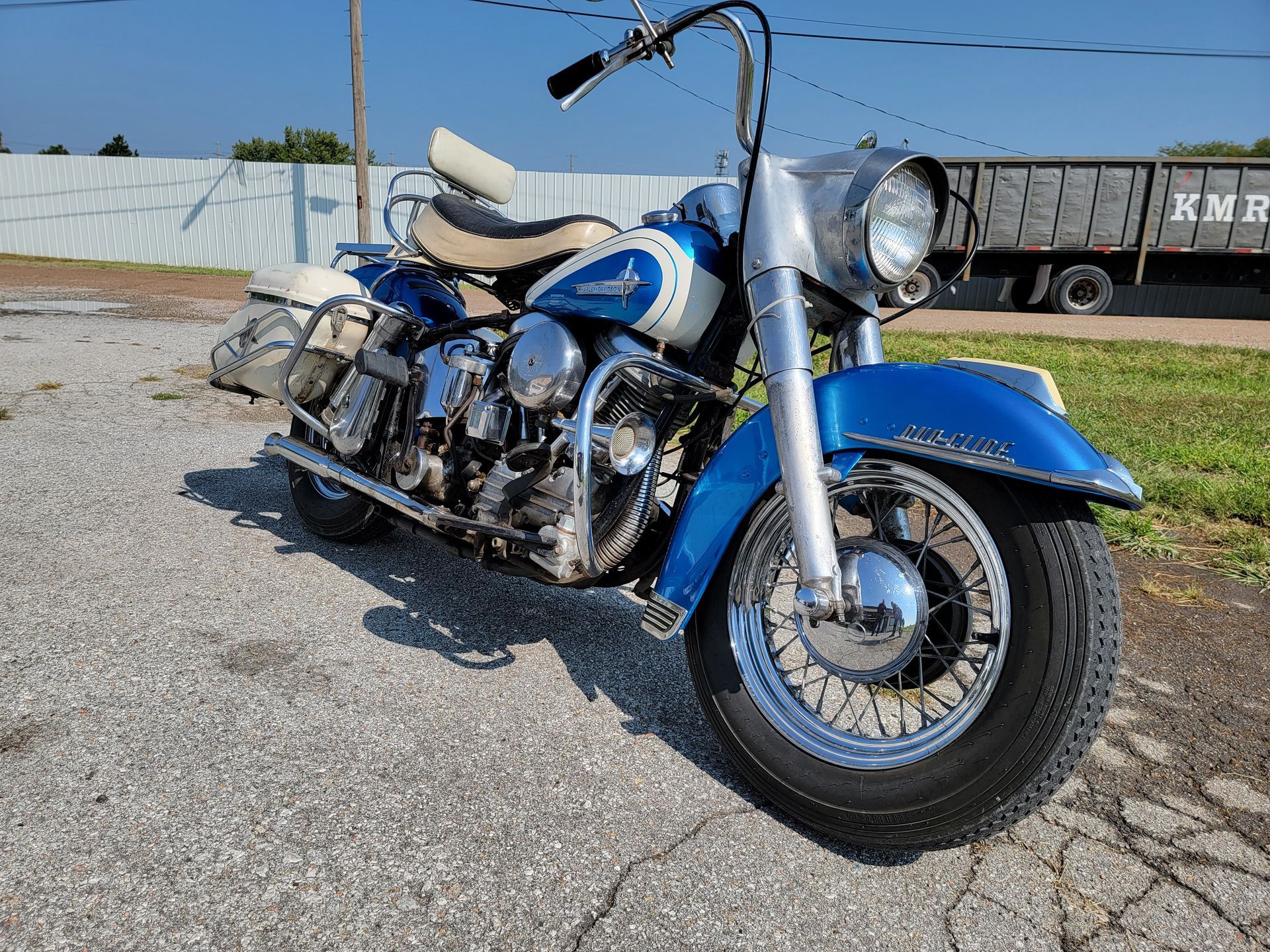 a blue and silver motorcycle is parked in a parking lot