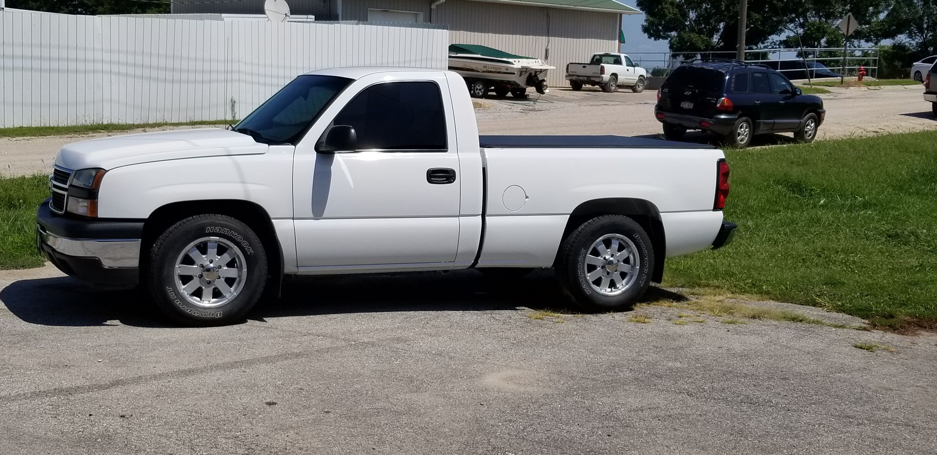 a white truck is parked on the side of the road