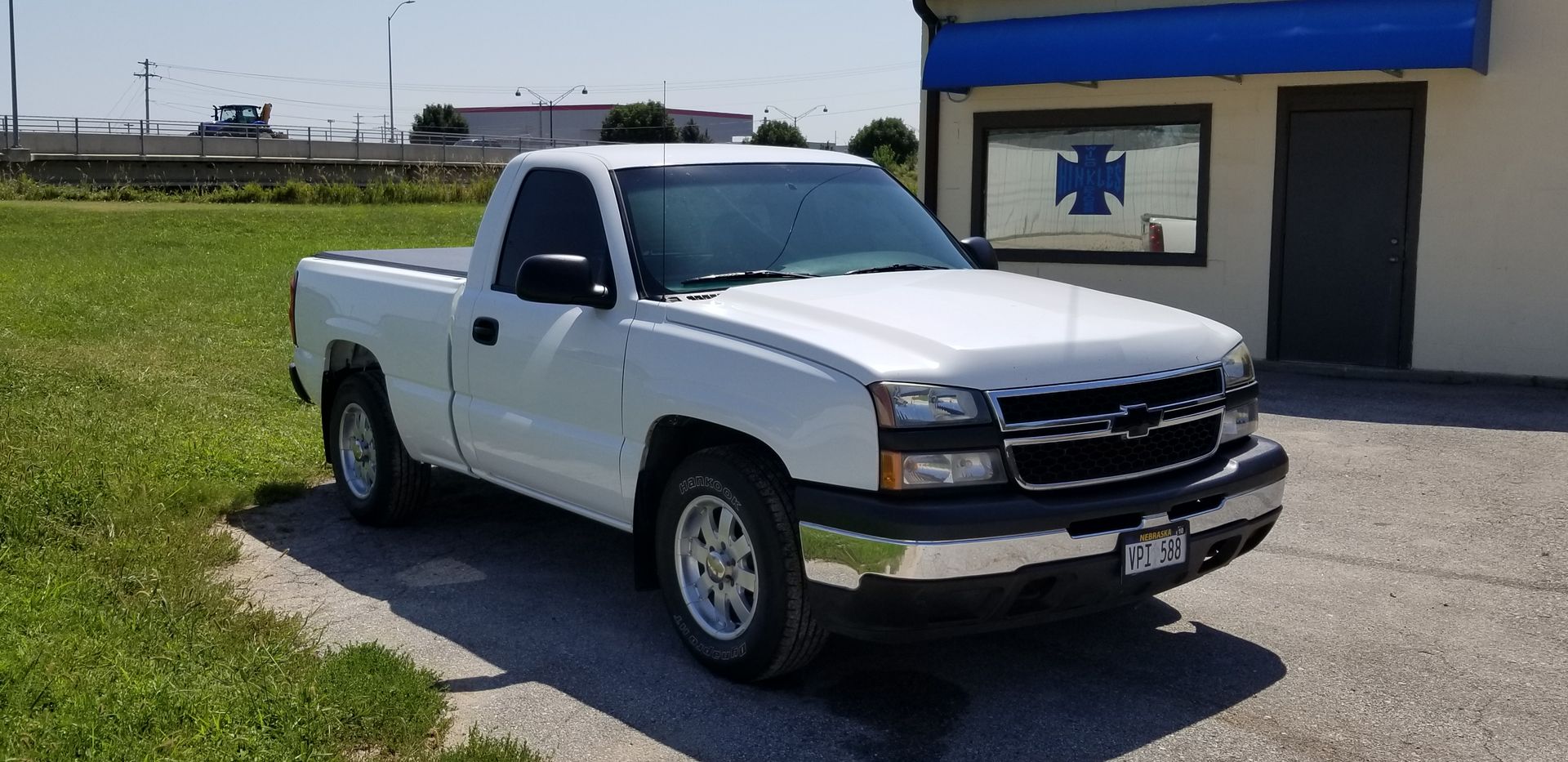 a white truck is parked in front of a building