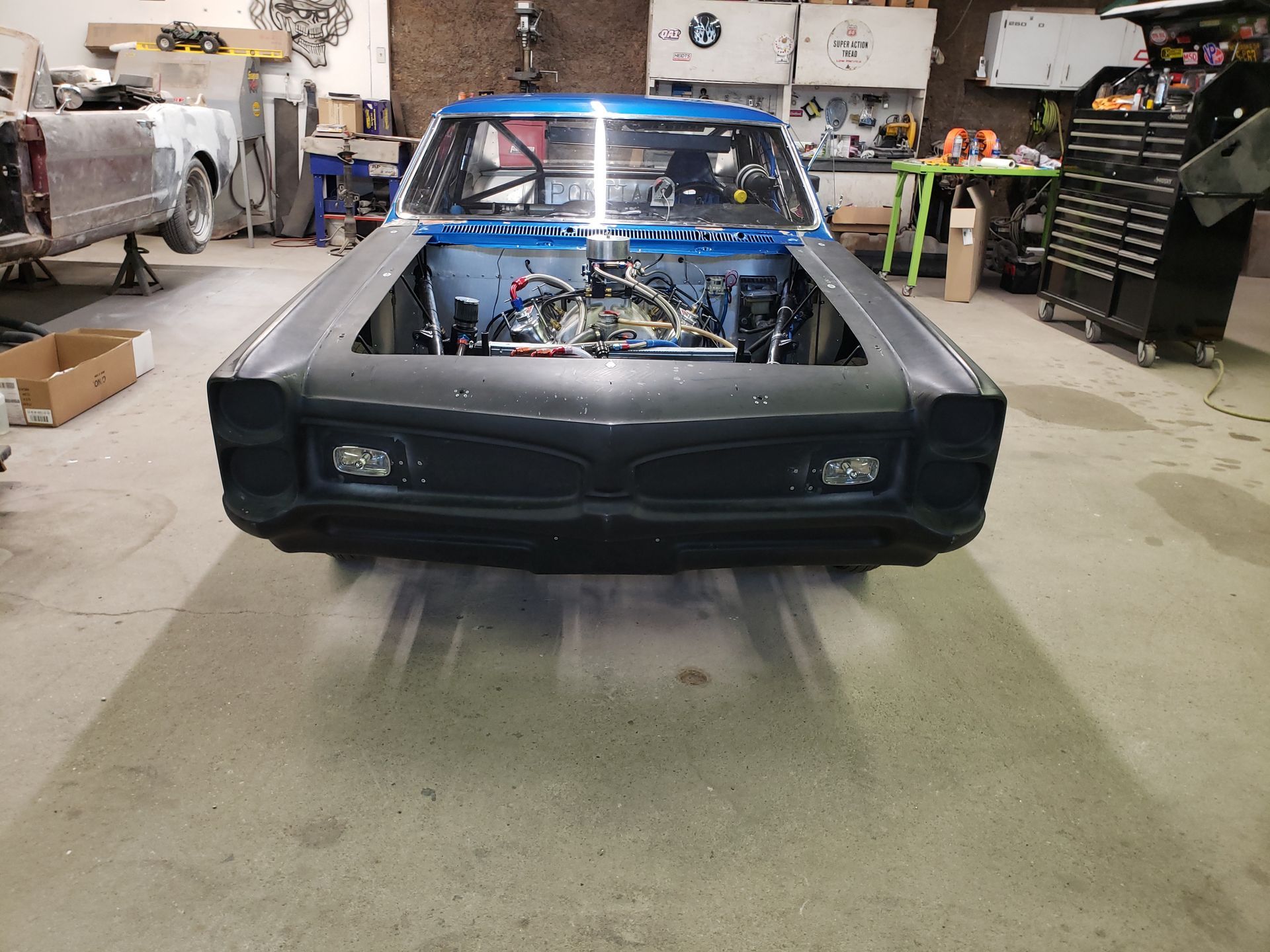a blue car is being built in a garage