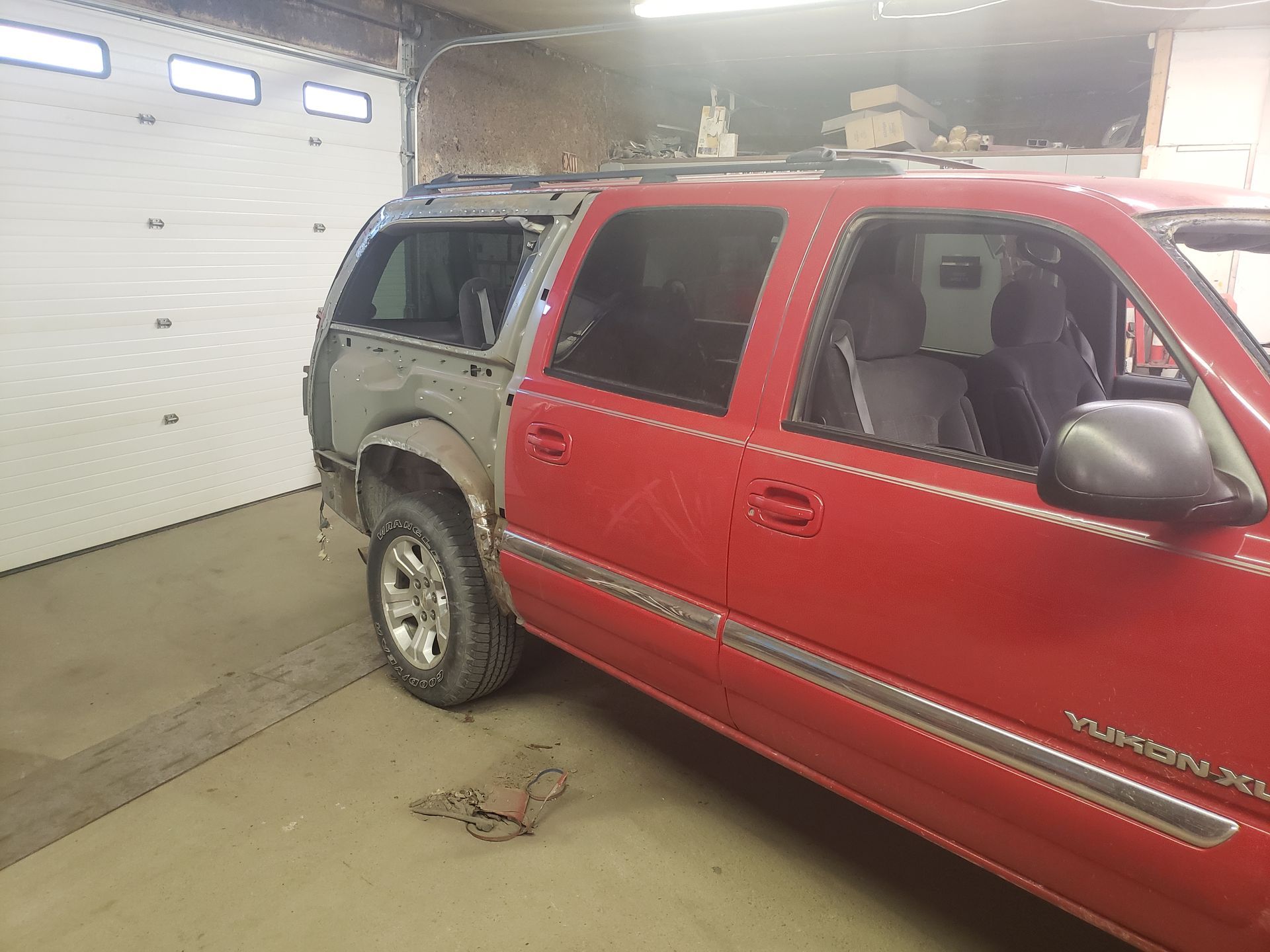 a red suv is parked in a garage next to a garage door