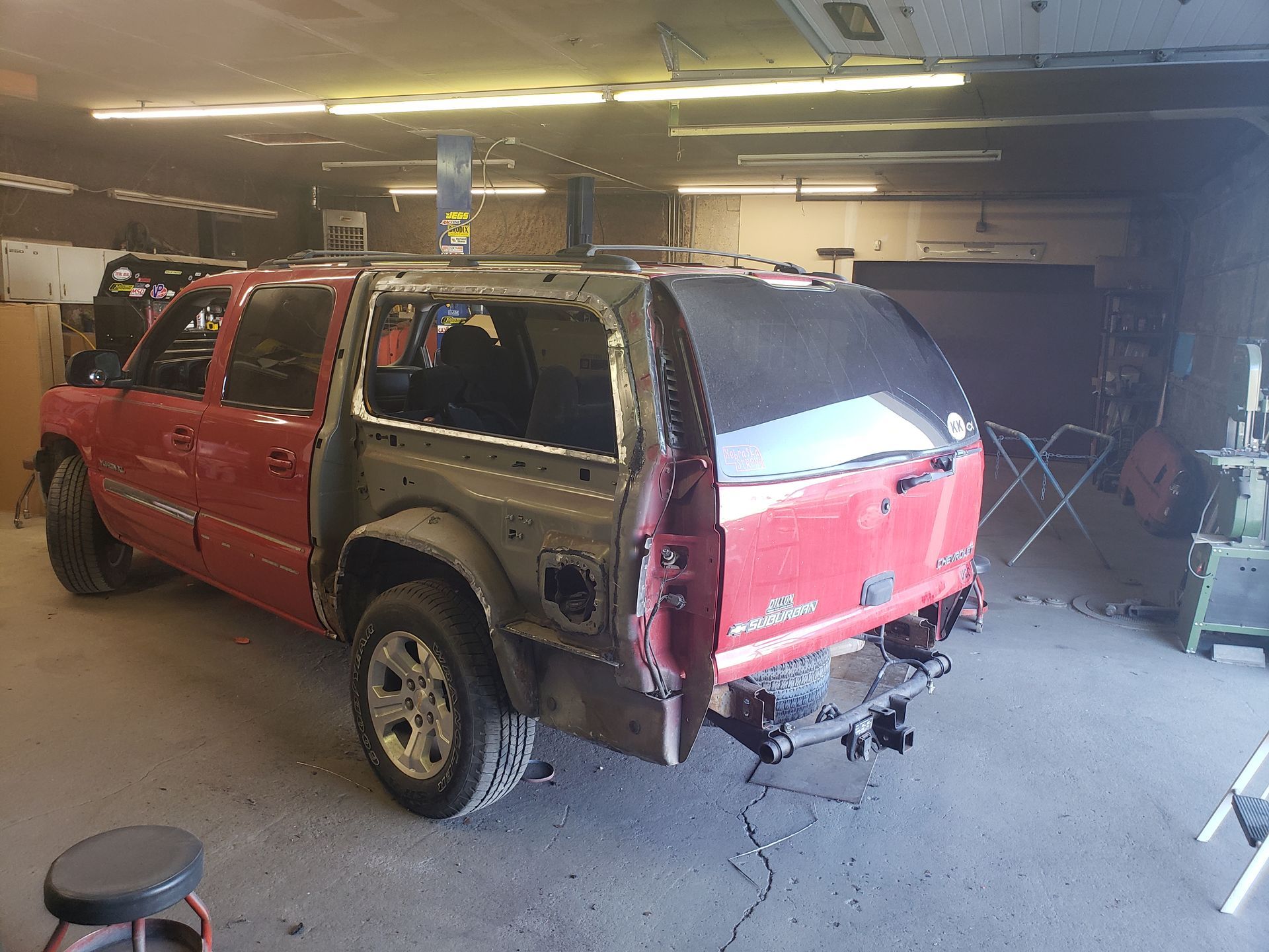 a red suv is being repaired in a garage