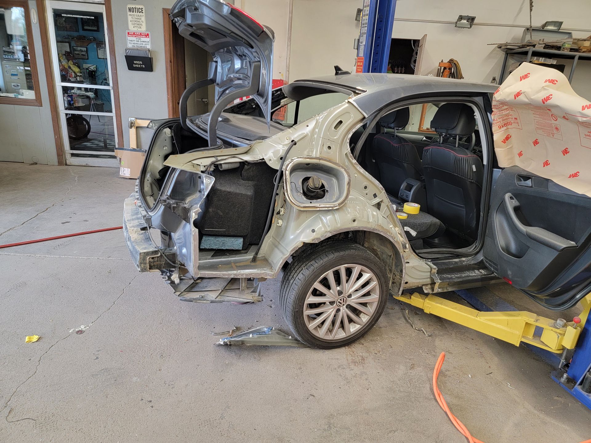 a car is being dismantled in a garage