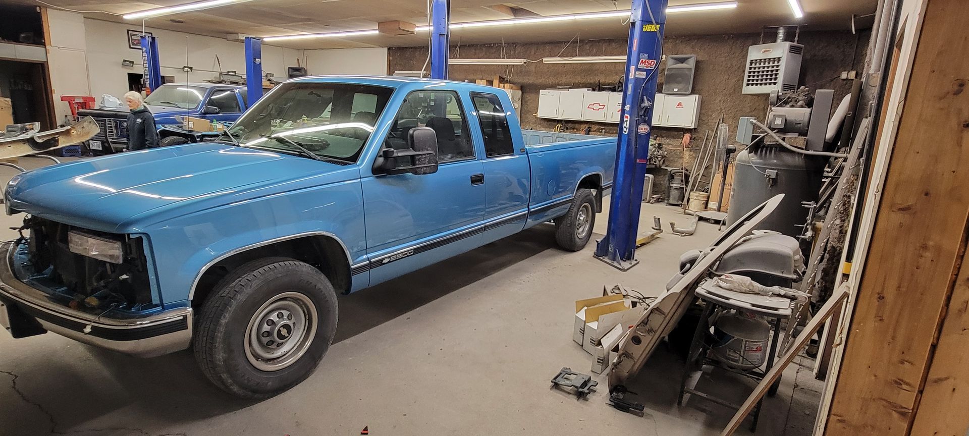 a blue truck is parked in a garage