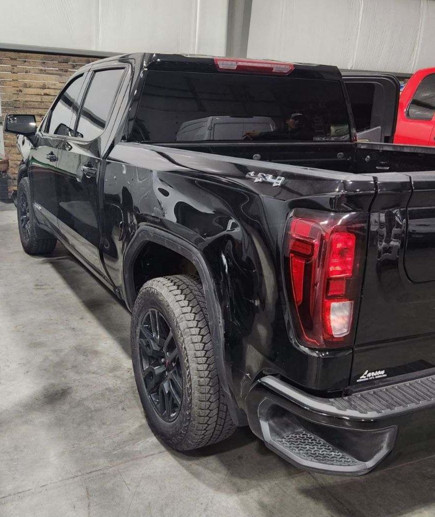 a black pickup truck is parked in a garage