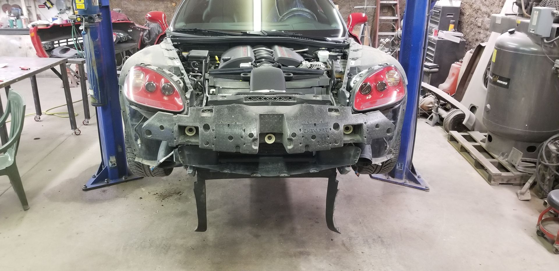 a car is sitting on a lift in a garage