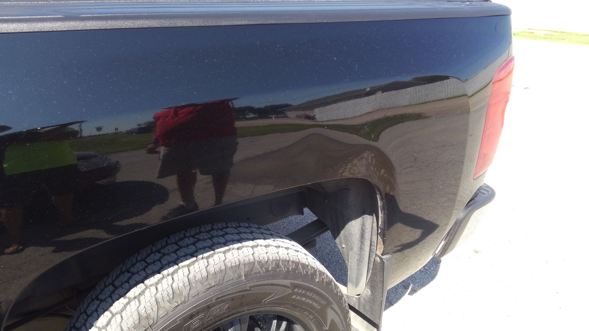 a black truck is parked on the side of the road