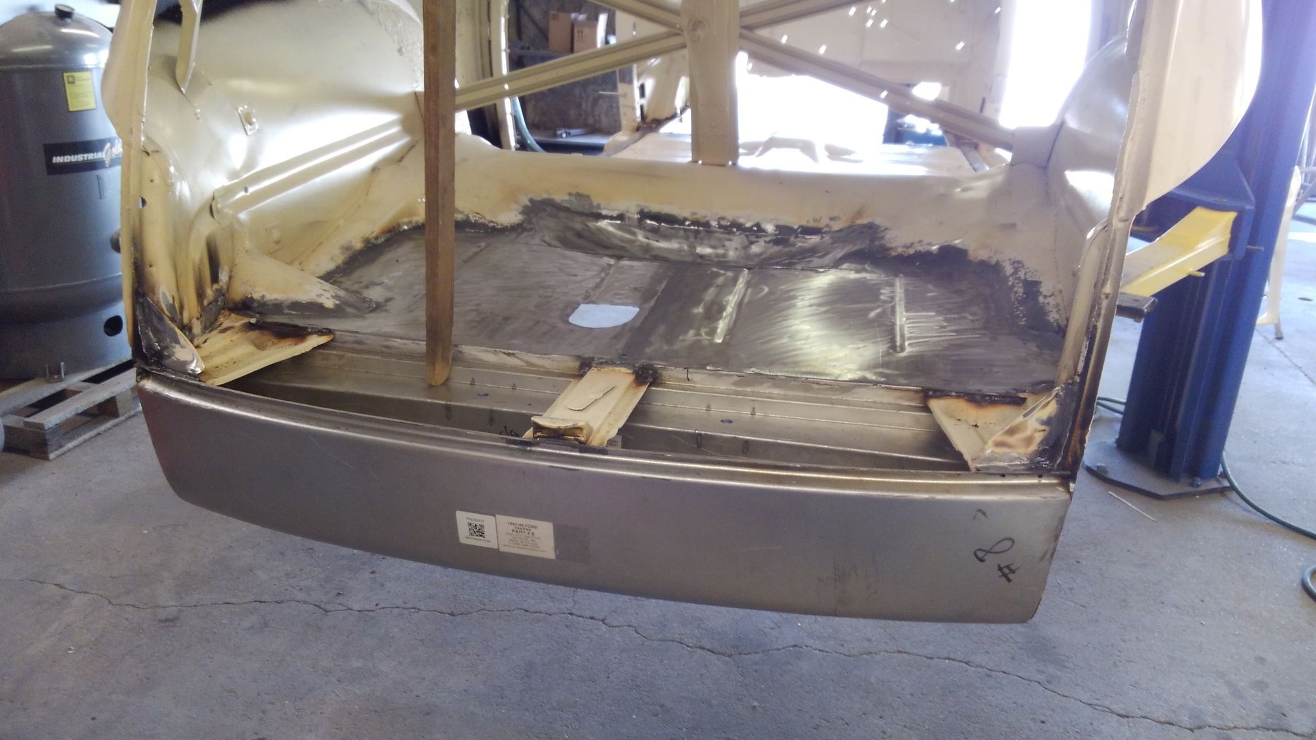 a car is sitting on a lift in a garage