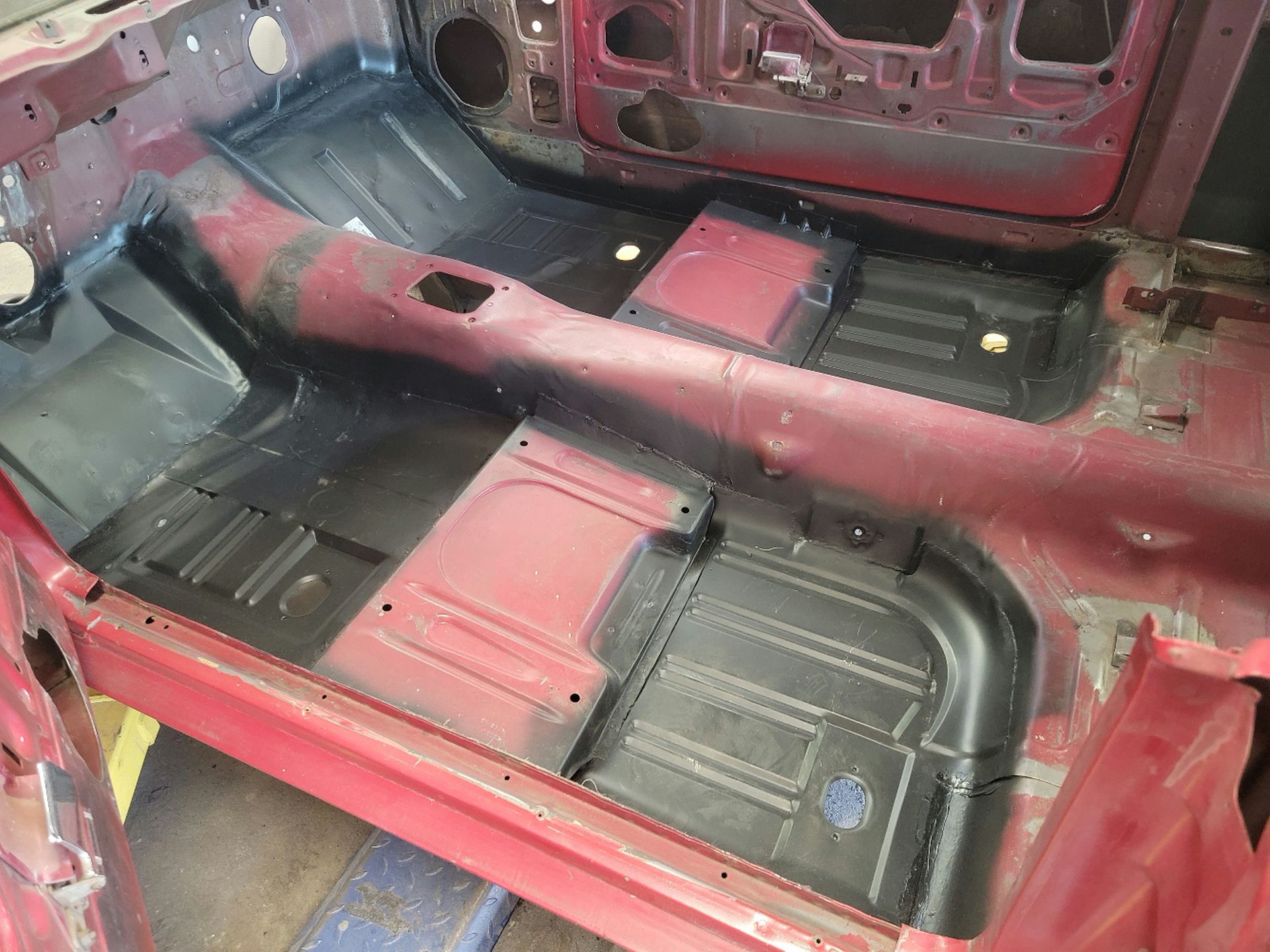 the inside of a red car is being dismantled