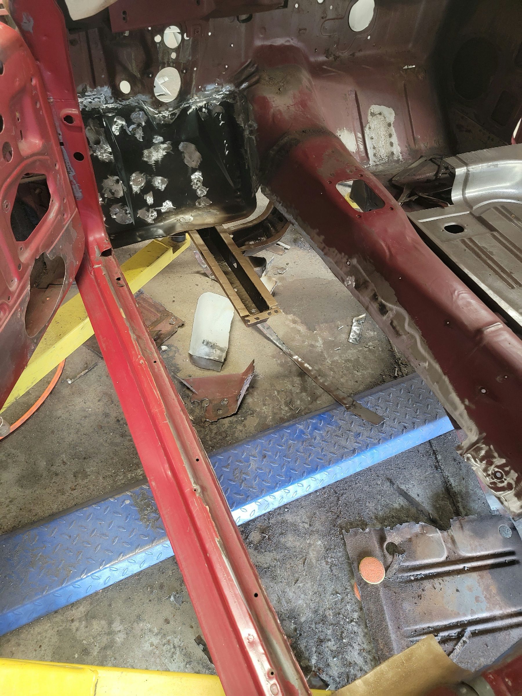 a red car is being dismantled in a garage