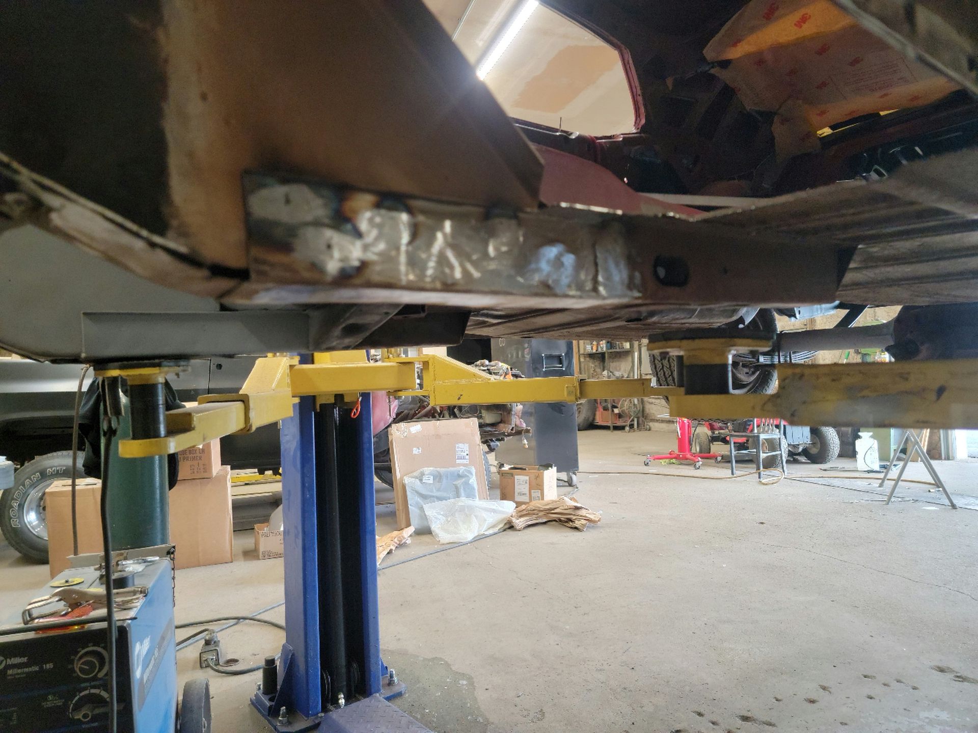 a car is sitting on a lift in a garage