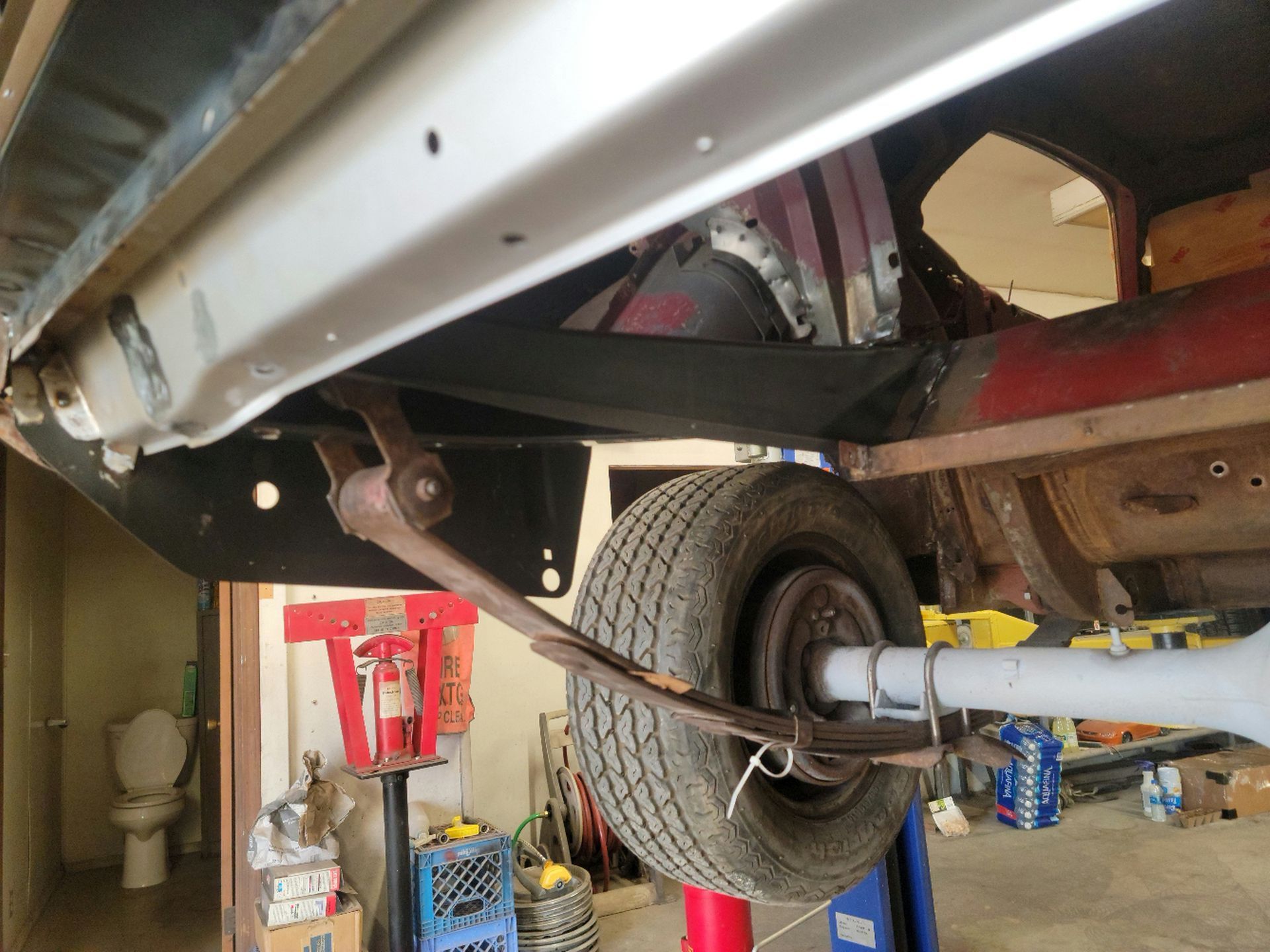 a car is sitting on a lift in a garage