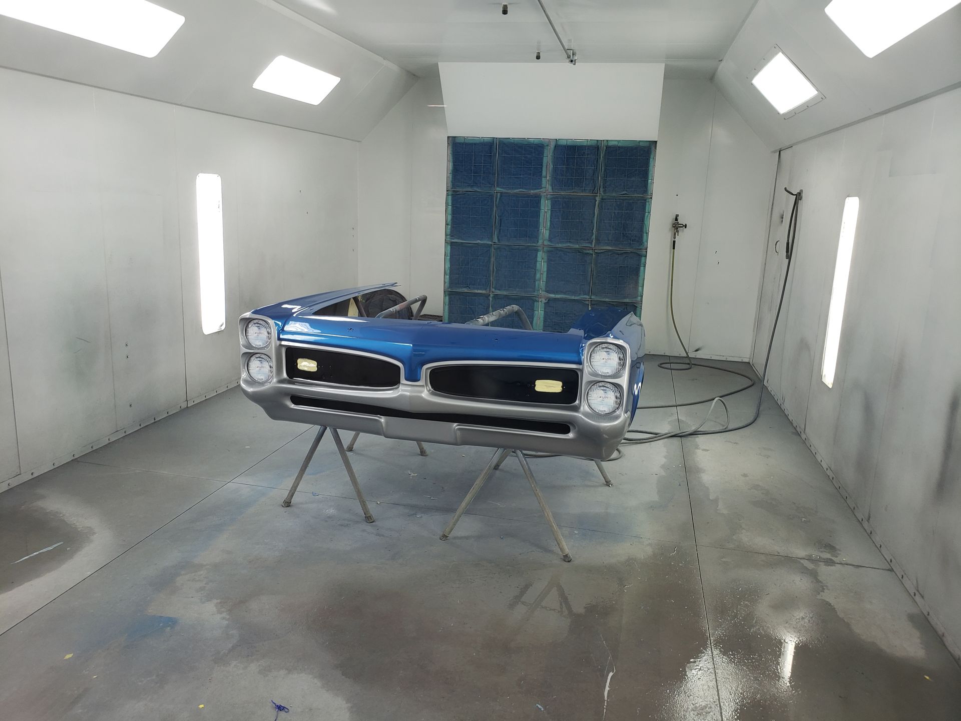 a car is being painted in a paint booth