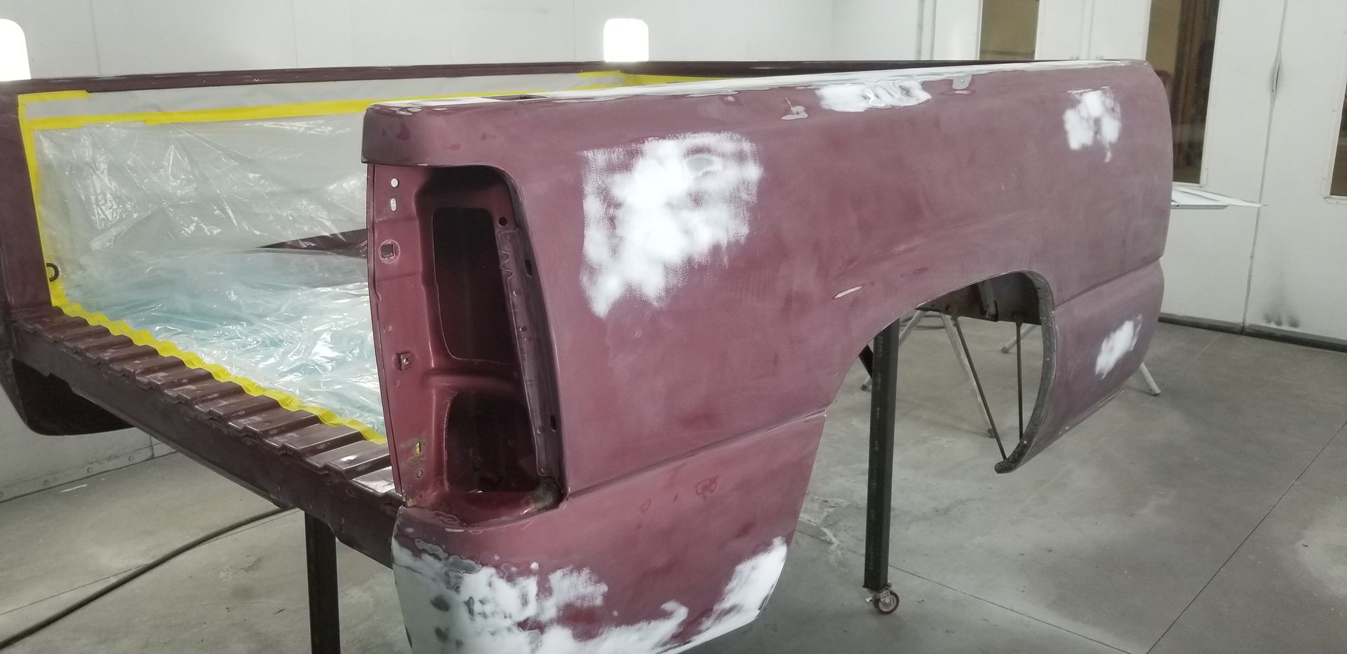 a truck bed is being painted in a paint booth