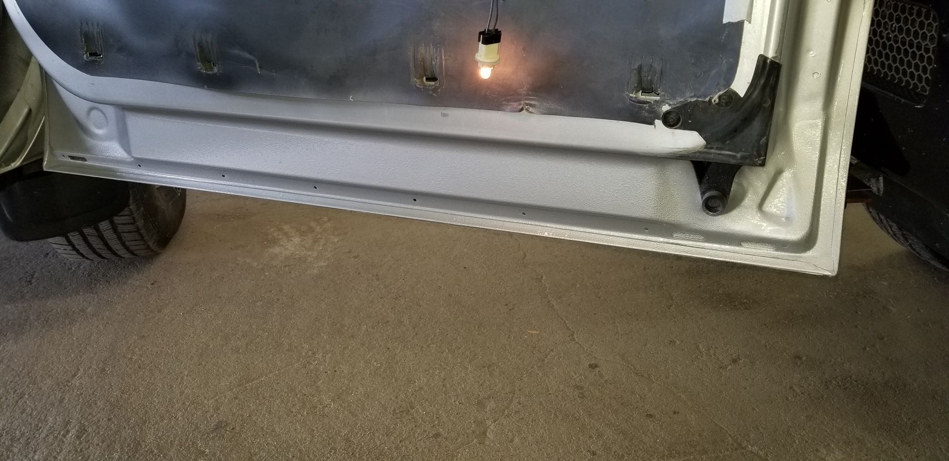 a close up of a car door with a light on it