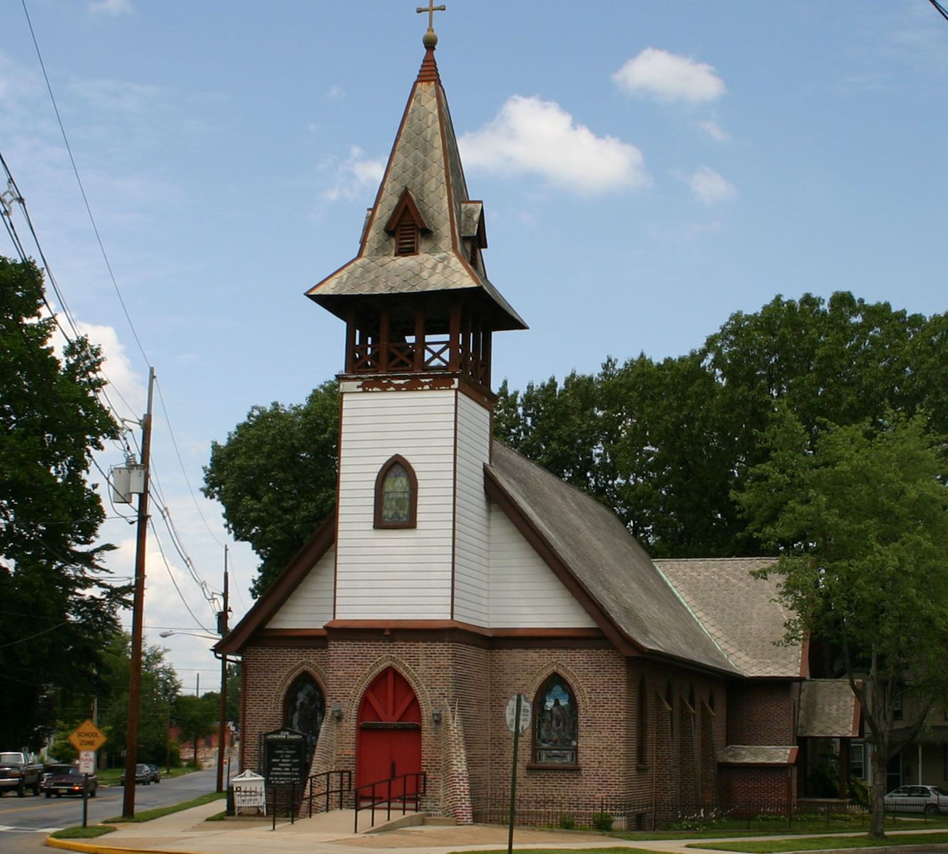 A church with a bell tower and a cross on top