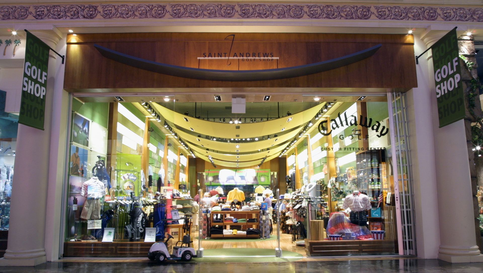 A golf shop with a golf cart in front of it