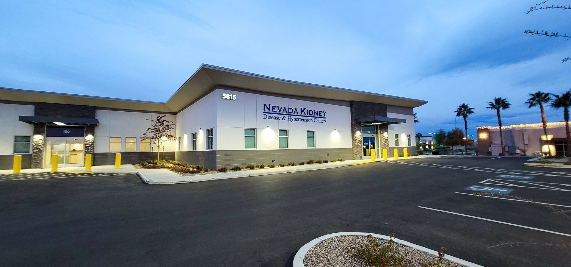 A large white building with a parking lot in front of it.