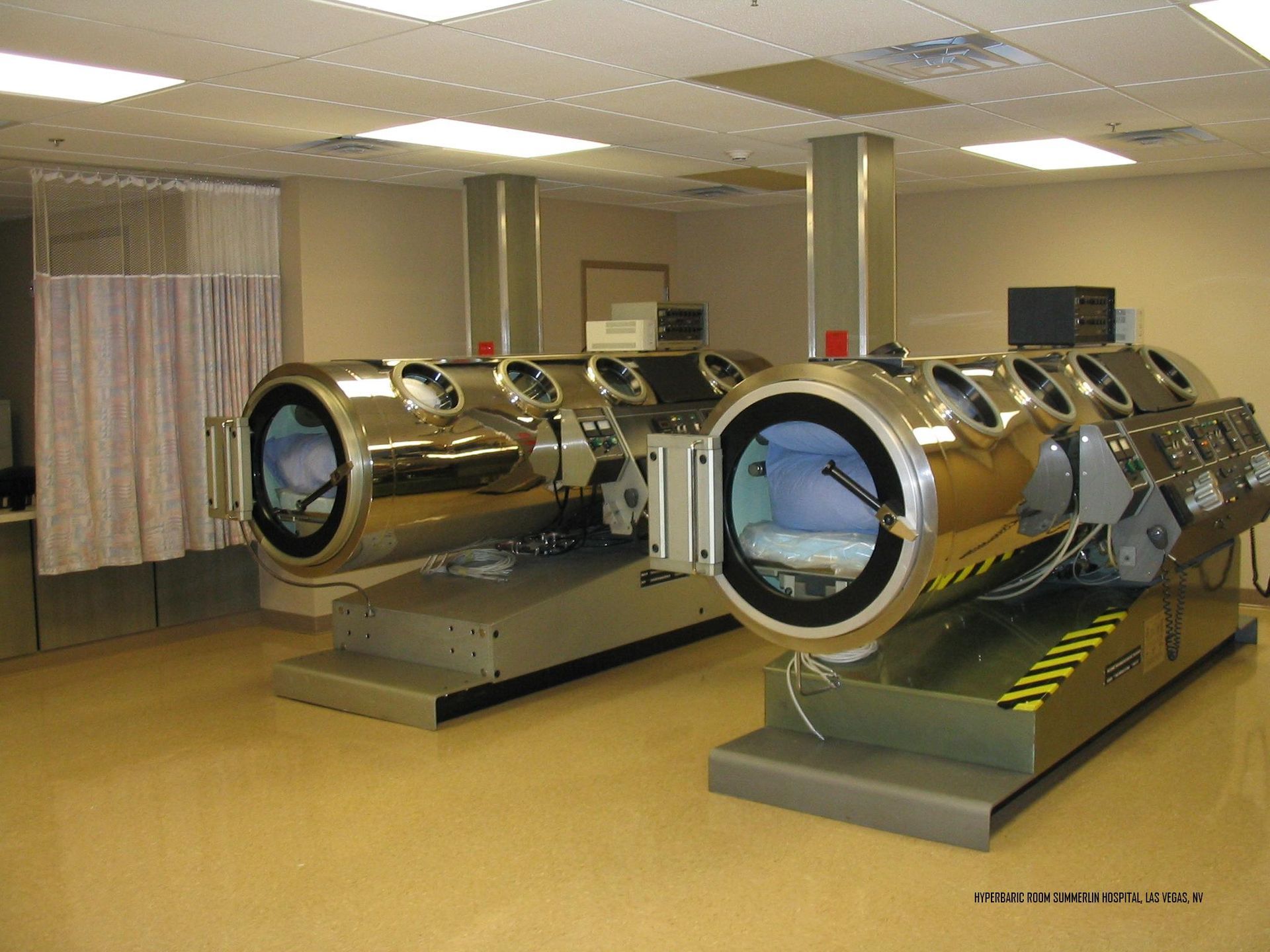 Two large stainless steel cylinders are sitting in a room