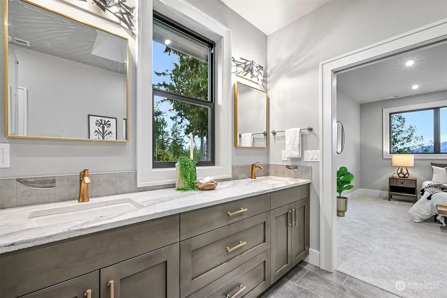 A bathroom with two sinks , a mirror and a window.