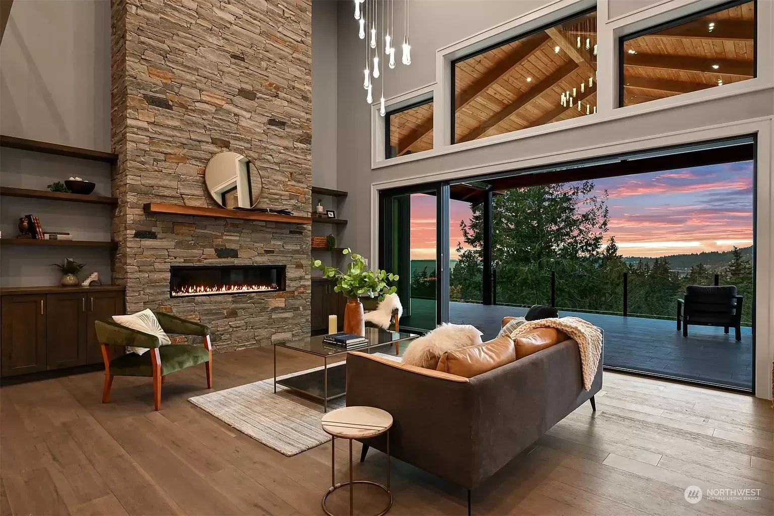A living room with a couch , fireplace and sliding glass doors.