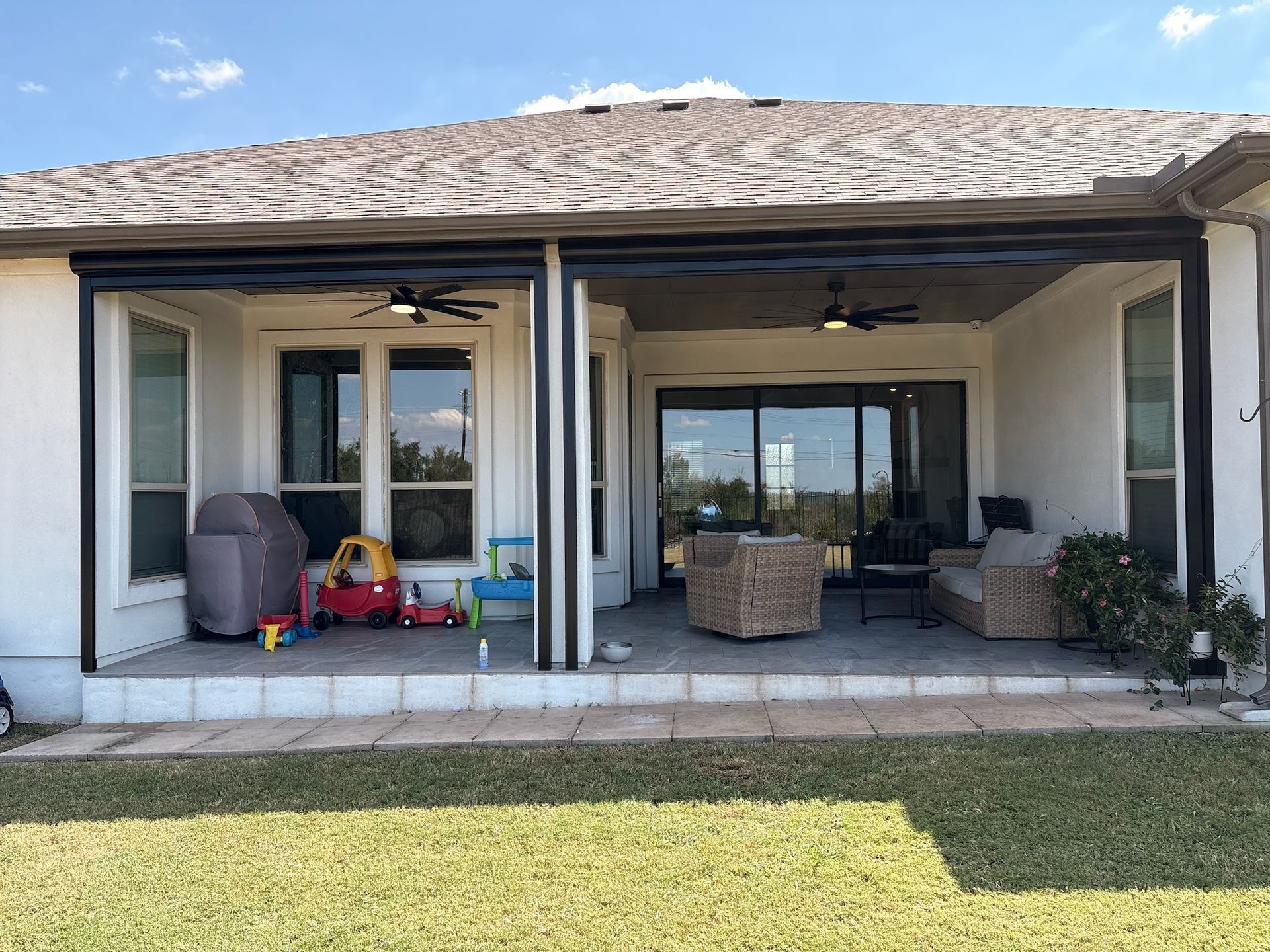 Patio with retractable screens, ceiling fans, and outdoor furniture.