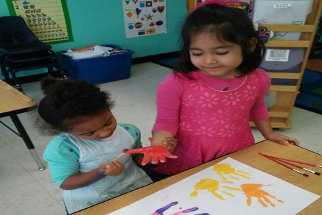 Children painting the handprints