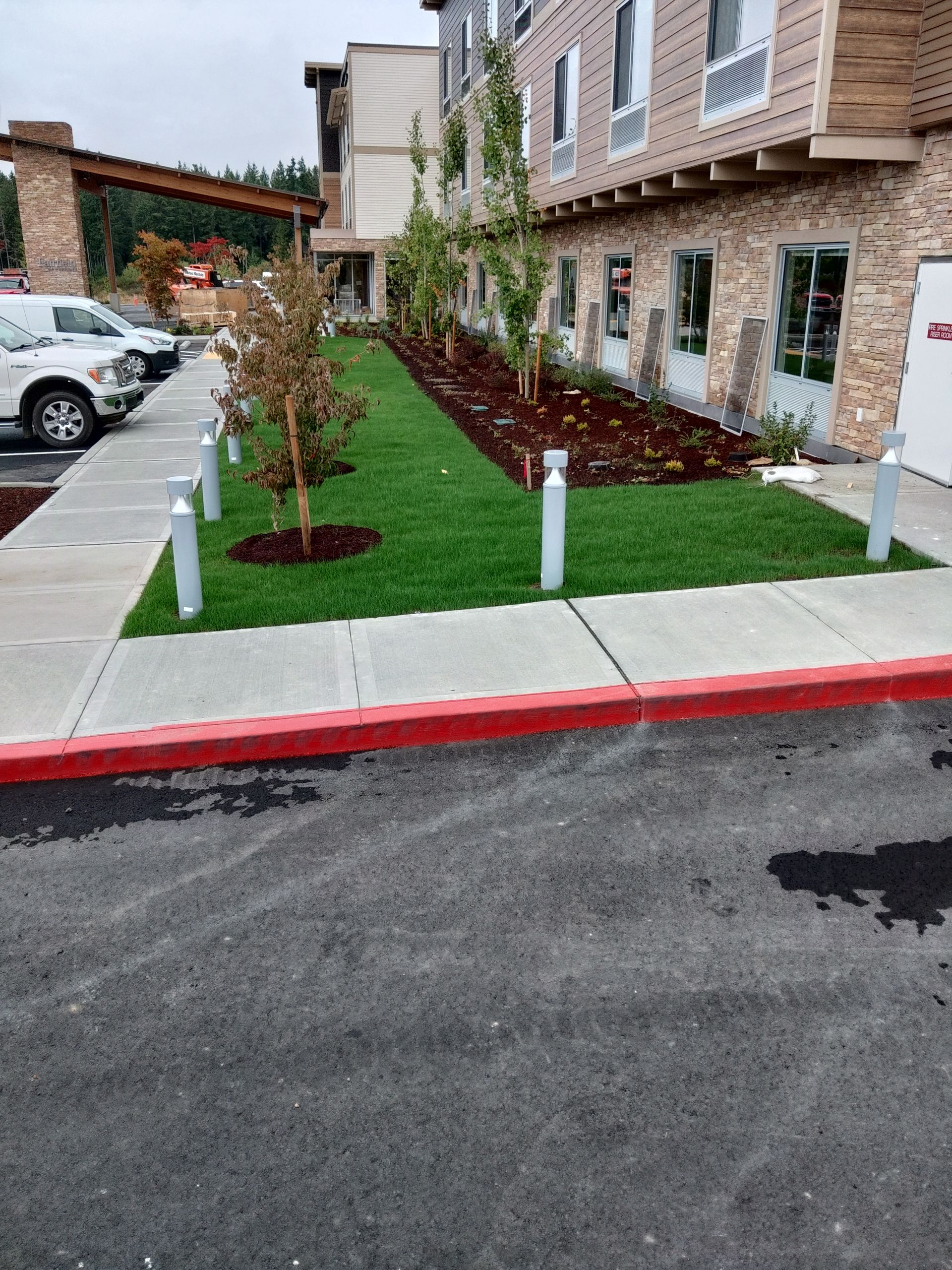 a parking lot with cars parked in front of a building