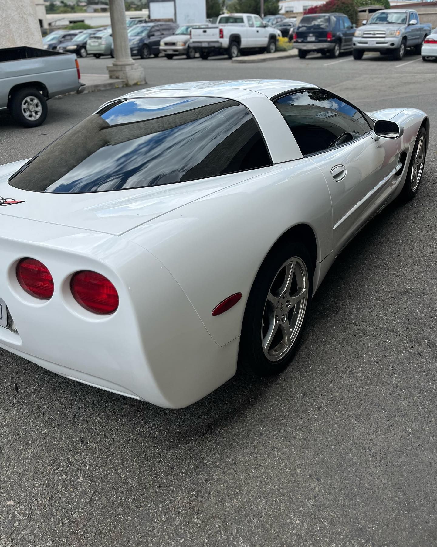 White Corvette parked on asphalt.