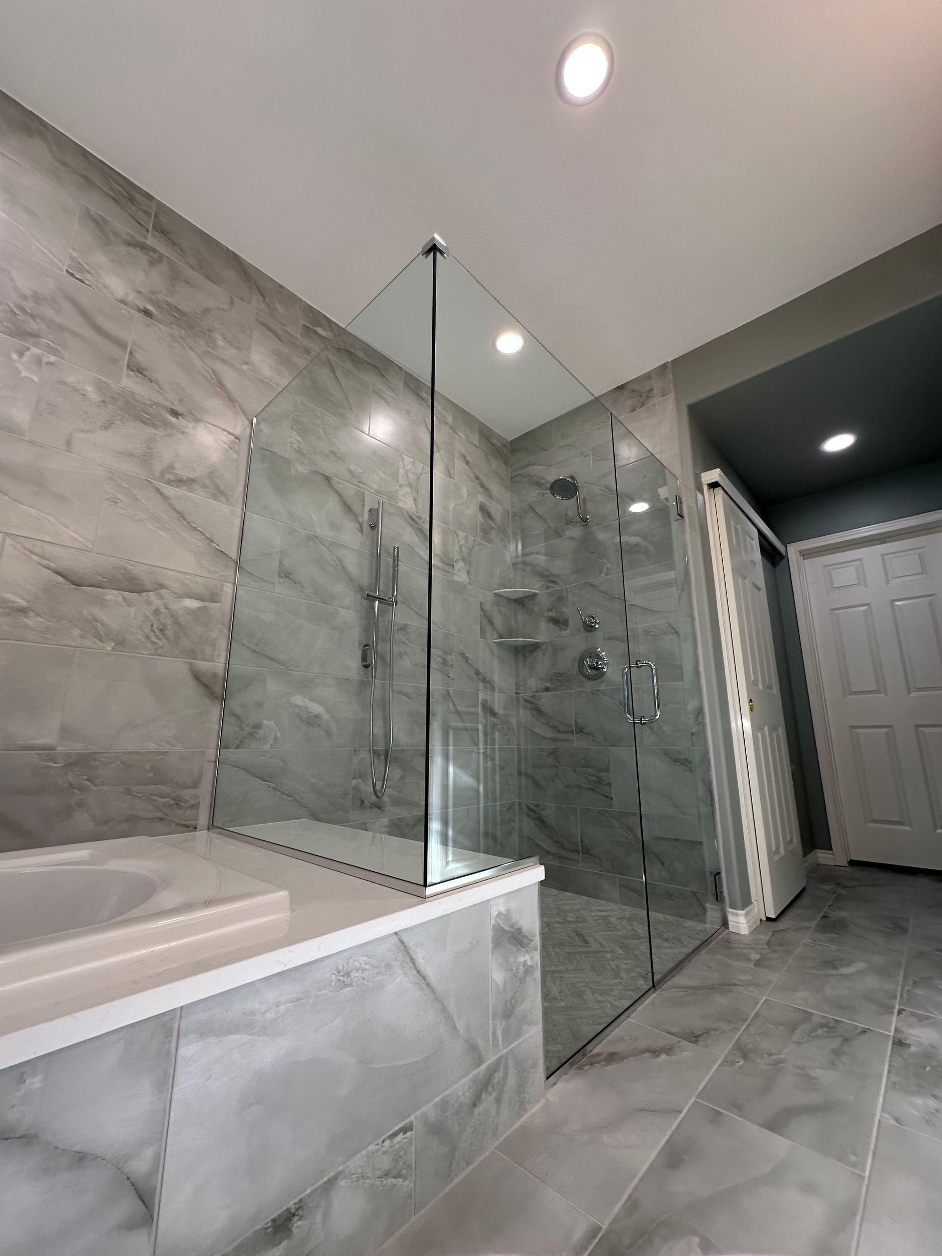A bathroom with a walk in shower and a bathtub